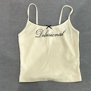 Garage white tank top with black trim, bow and delusional on front
